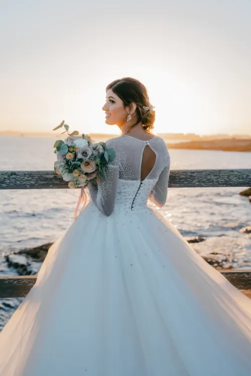 Bride and groom with a garden-style floral arrangement