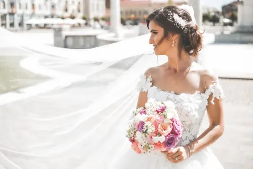 Elegant white and green bridal bouquet held by a bride