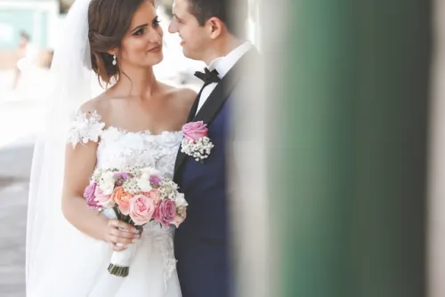 Whimsical wedding bouquet with mixed blooms and trailing ribbons